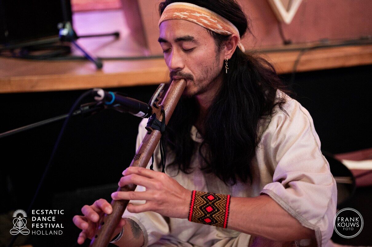 A musician playing live as evening falls