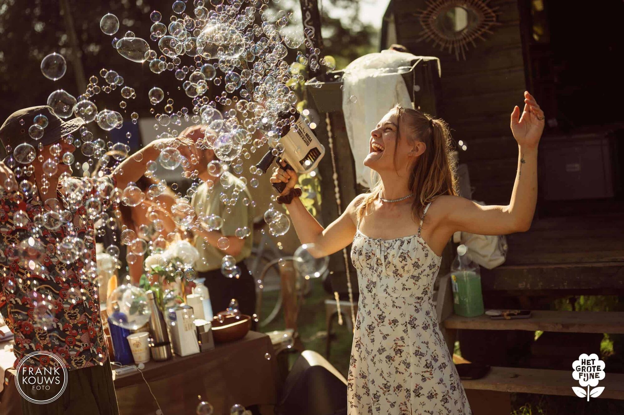 A woman dancing in sunlight between soap bubbles