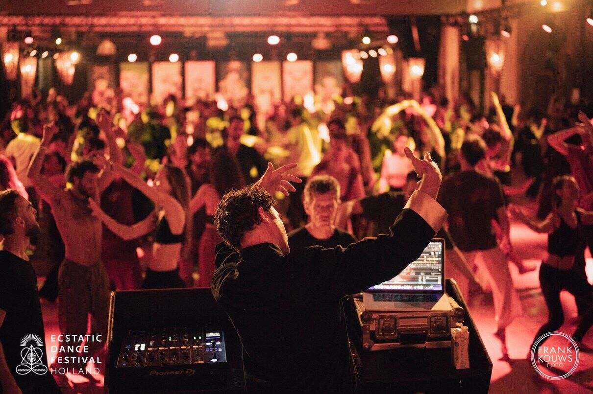A warm dance floor at night, hands in the air